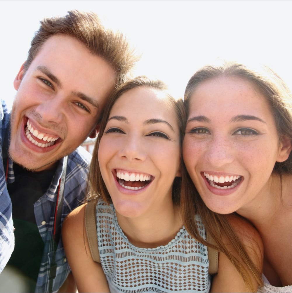 group of young adults smiling and laughing